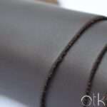 Close-up view of Cyclone Choco Brown Finished Leather with visible edges
