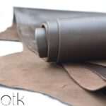 Multiple layers of Cyclone Choco Brown Finished Leather rolled and laid out