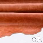 Close-up texture of premium Tiffany Orange finished leather in 1.2-1.4mm thickness