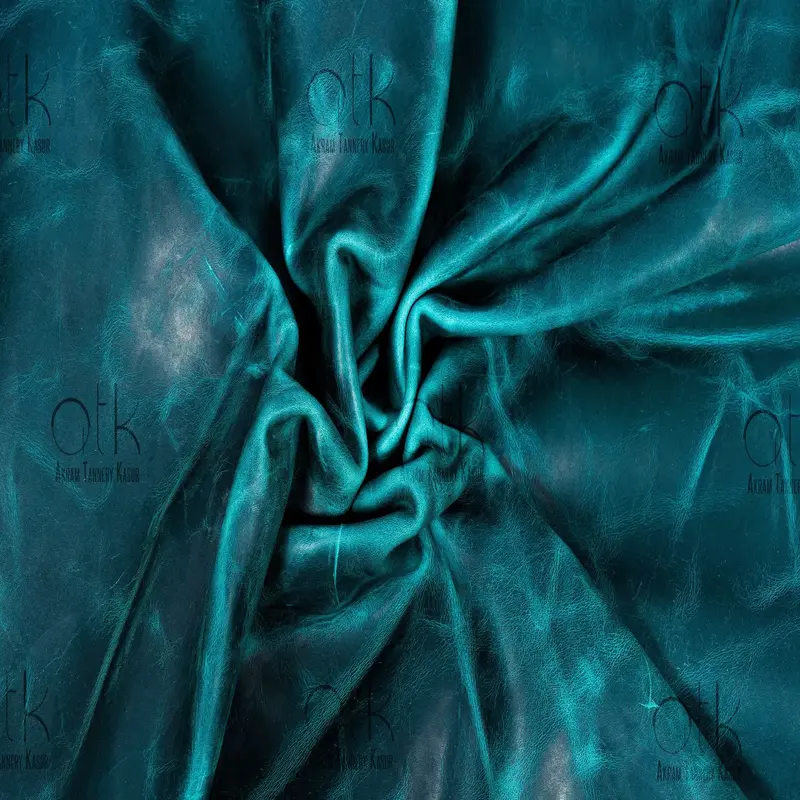 Oceanic Wave Pull-up Leather in deep teal, exhibiting natural texture for luxury fashion.