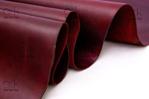 Richly hued maroon pull-up leather suitable for fashion-forward leather pieces.