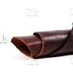 Curled roll of Horween Ranger Tan leather.