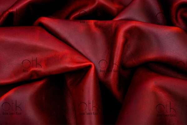 Vibrant maroon pull-up leather, ready for crafting high-quality leather products.