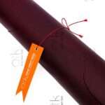 Maroon pull-up leather piece displaying rich texture for bespoke accessories.