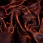 Rolled Horween leather in ranger tan revealing texture and color.