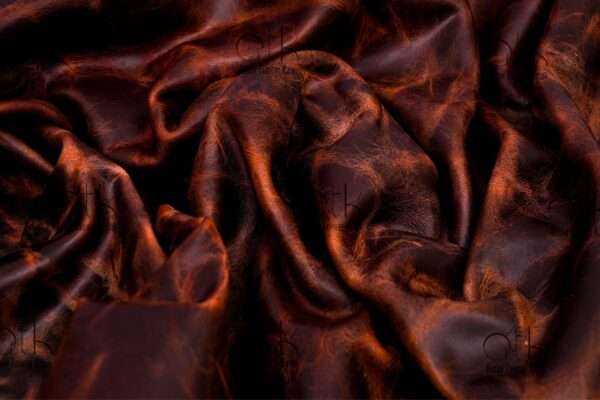 Rolled Horween leather in ranger tan revealing texture and color.